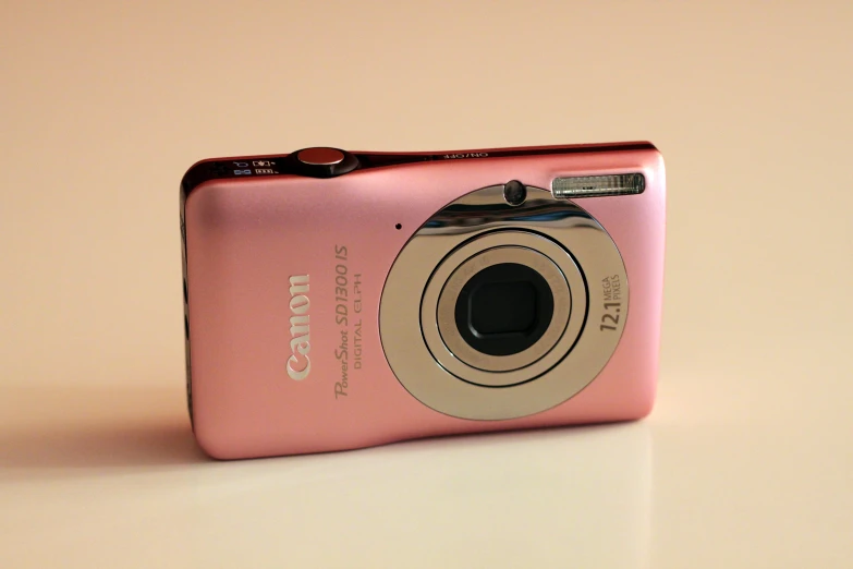 a pink digital camera sitting on top of a counter