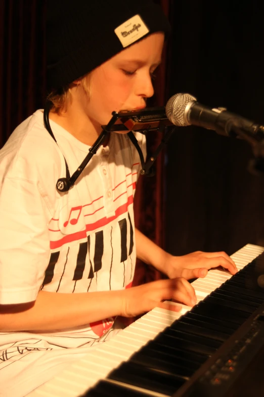 a girl playing a musical instrument with a microphone on her side