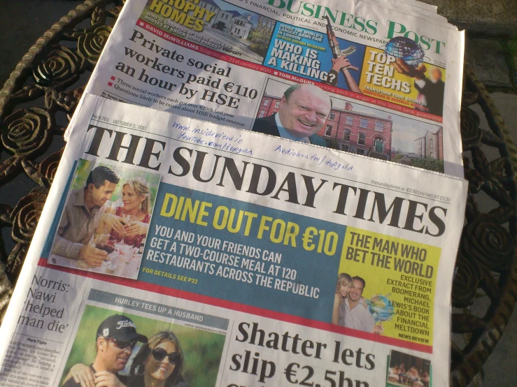 the newspaper is lying down on top of a table