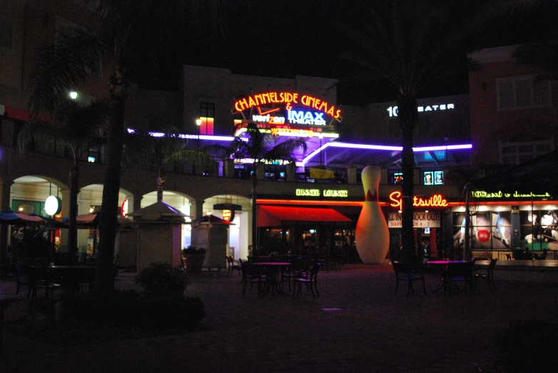 the outside of a restaurant at night with neon lights