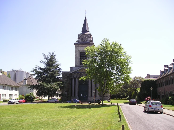 a city clock tower with a long sidewalk passing by