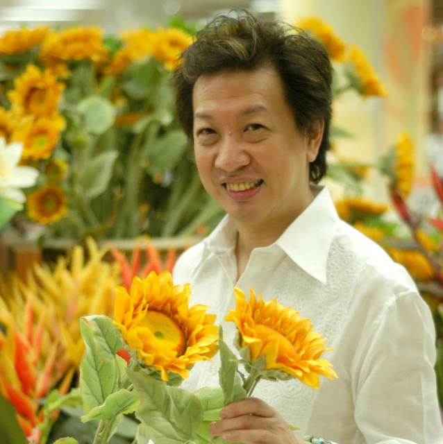 a man in a shirt holding some flowers