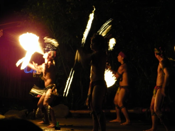 people dressed in different colors and sizes and holding torches