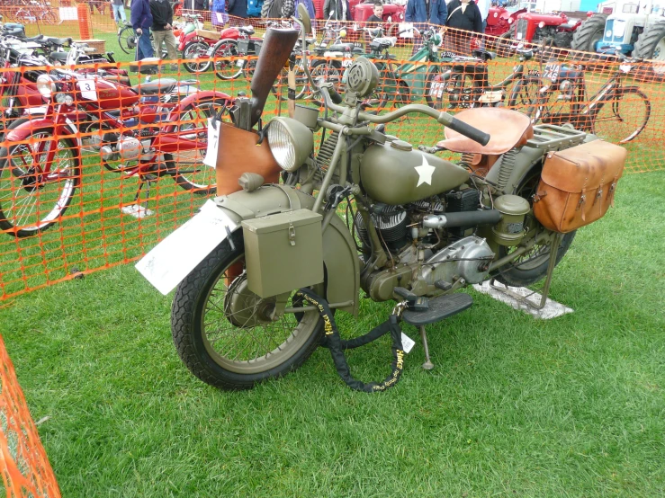 an old bike sitting on top of grass