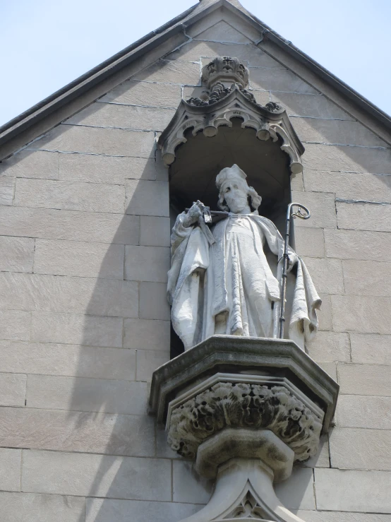 a statue of a man on top of a large stone building