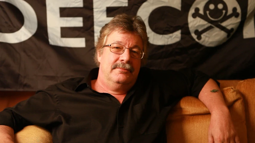 a man in black shirt sitting on a couch