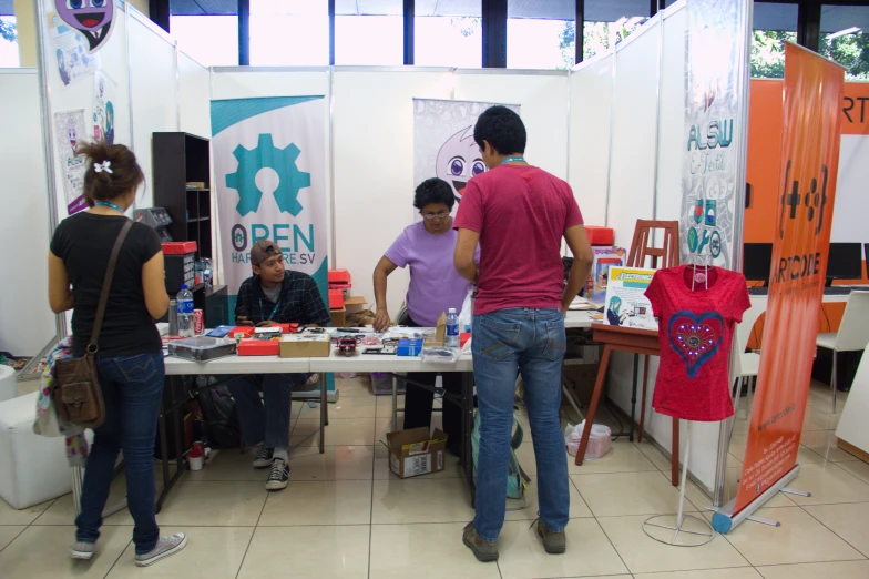several people are looking at the products on display