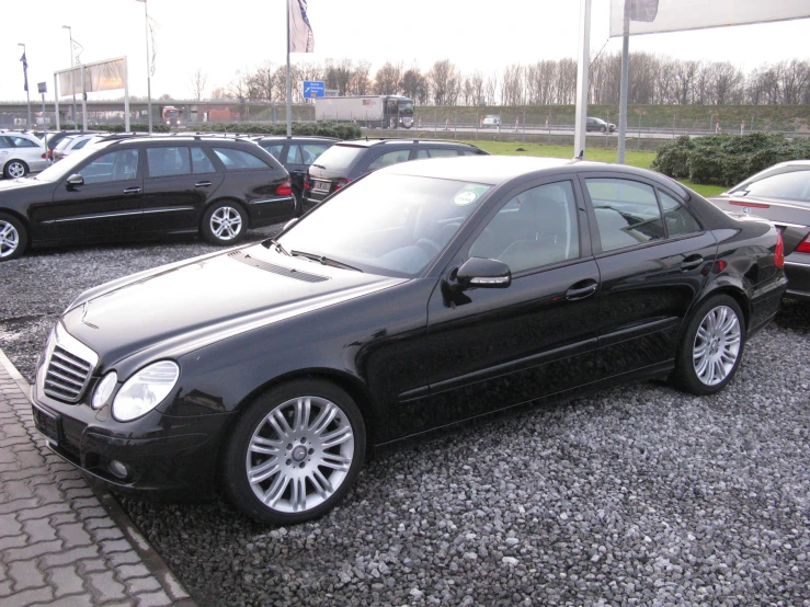 two black cars are parked in the parking lot