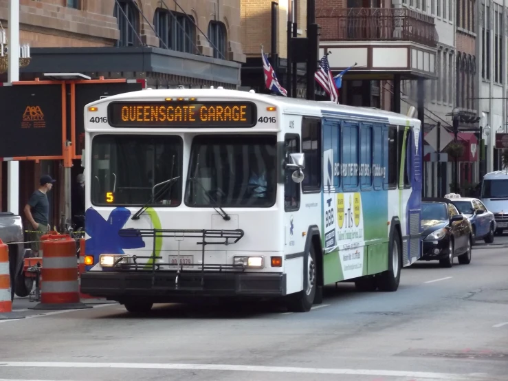 a city bus is riding along a street