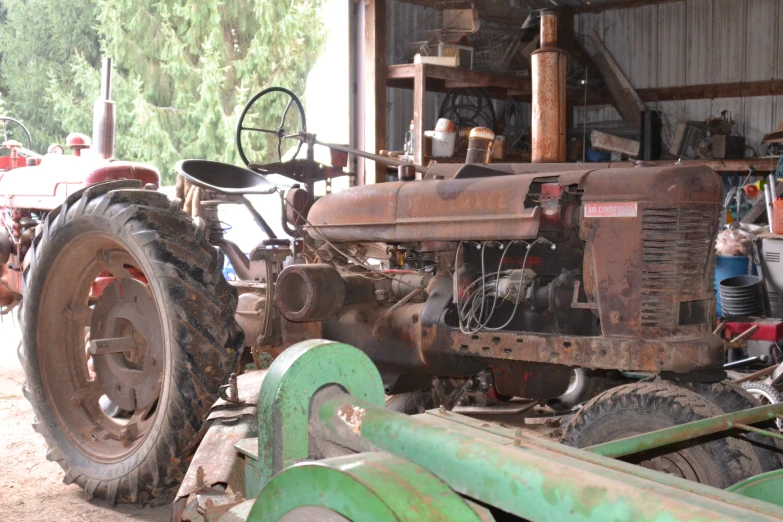 the front end of an antique tractor with it's tires down