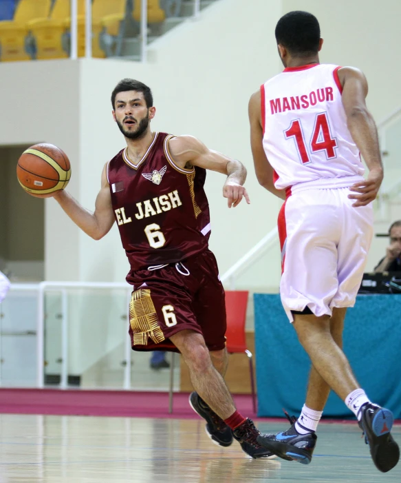 two basketball players in red jerseys running past each other