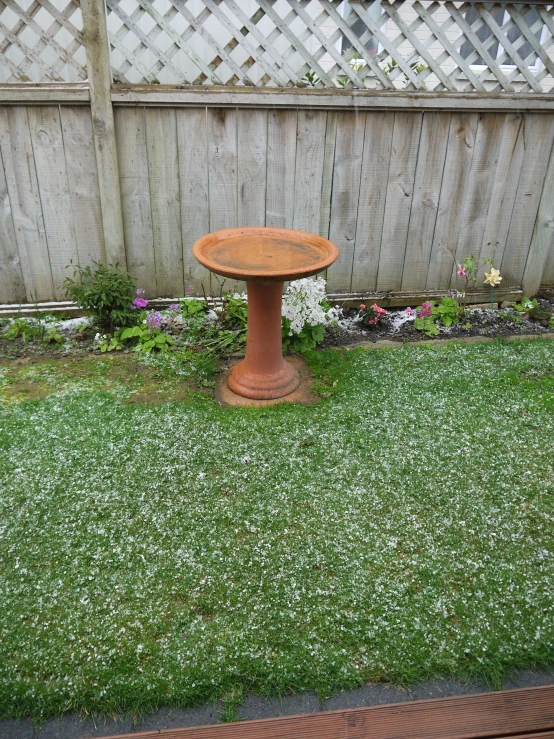 a small wooden table in the middle of a grass field