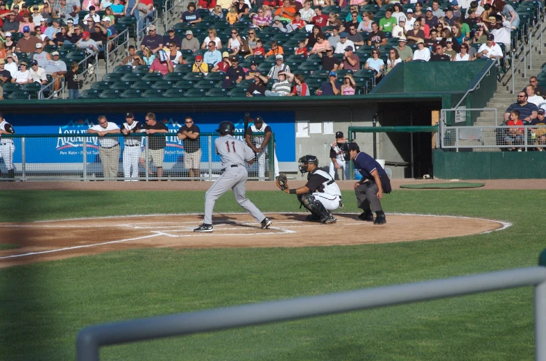 a baseball player swings at a pitch during a game