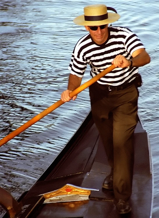 man paddling his boat on a river