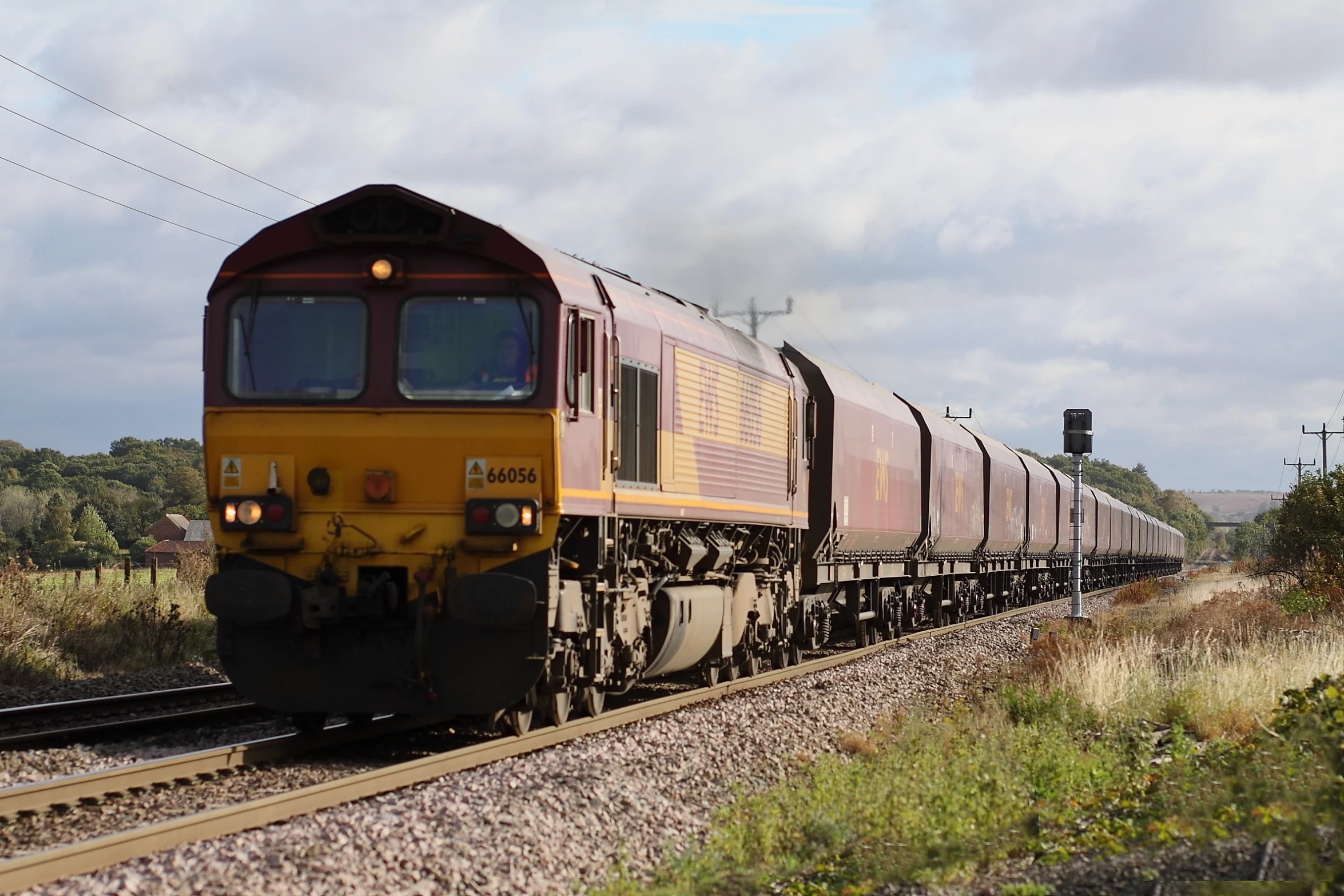 a train is traveling down the track in the country