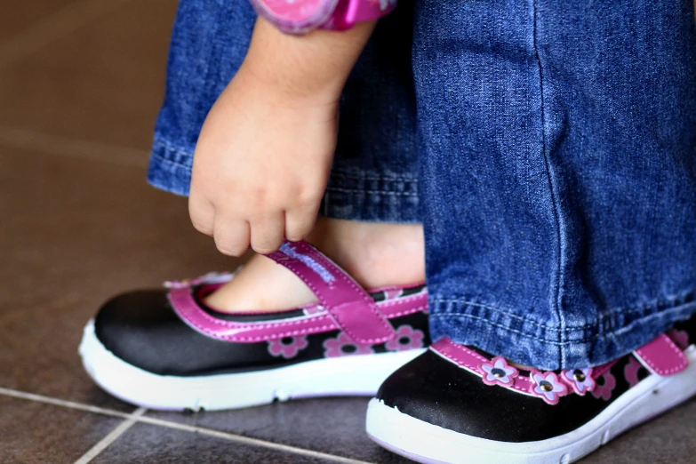 a young child standing on top of a tile floor