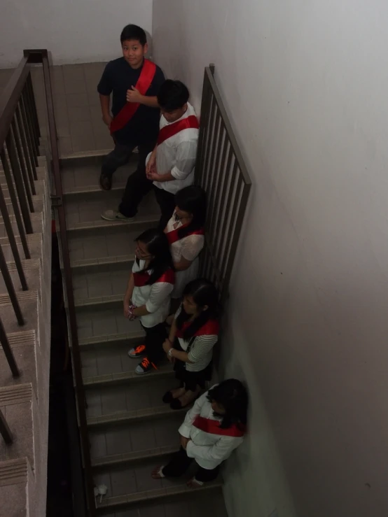 five people are in a room on top of stairs