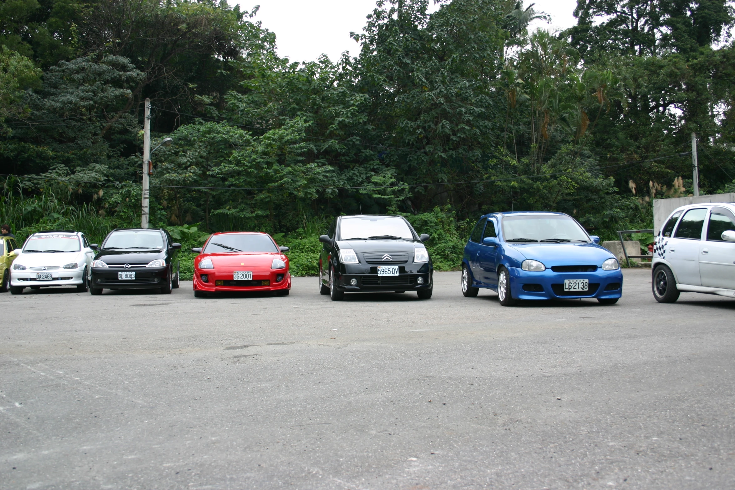 five different types of cars lined up in a parking lot