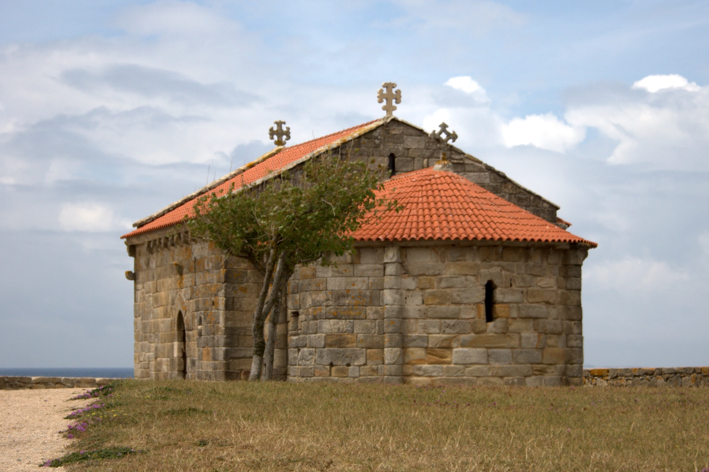 a church sitting on top of a stone hill