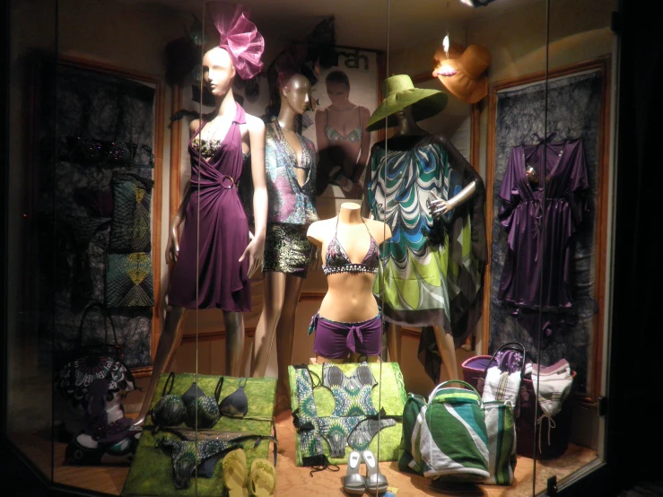 three mannequins dressed in various fashion clothes