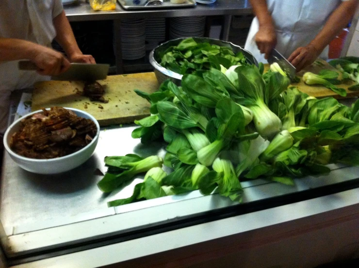 a kitchen counter filled with greens and food on it