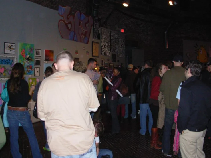 a large group of people standing around in a room