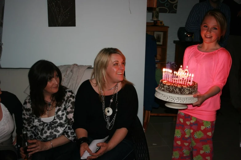 a person holds a plate with candles on it