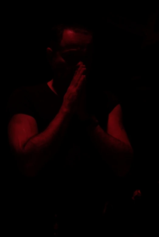 the silhouette of a man with his hands in his hands