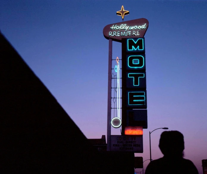 the el sign above the motel at dusk
