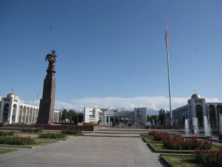 a street with buildings and fountains in front of it