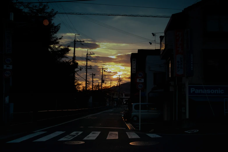 some power lines over an intersection with sunset