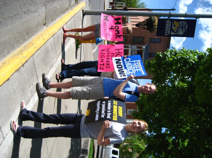 a group of people hold signs in protest of political benefits