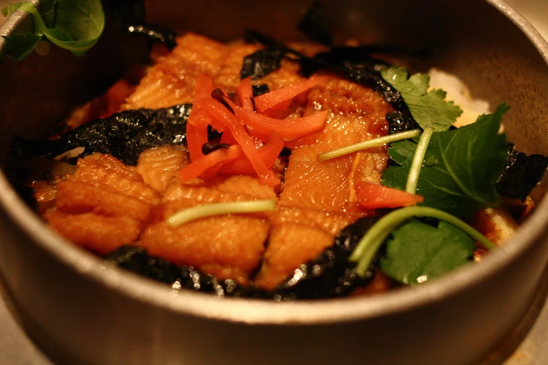 a bowl filled with food sitting on a table