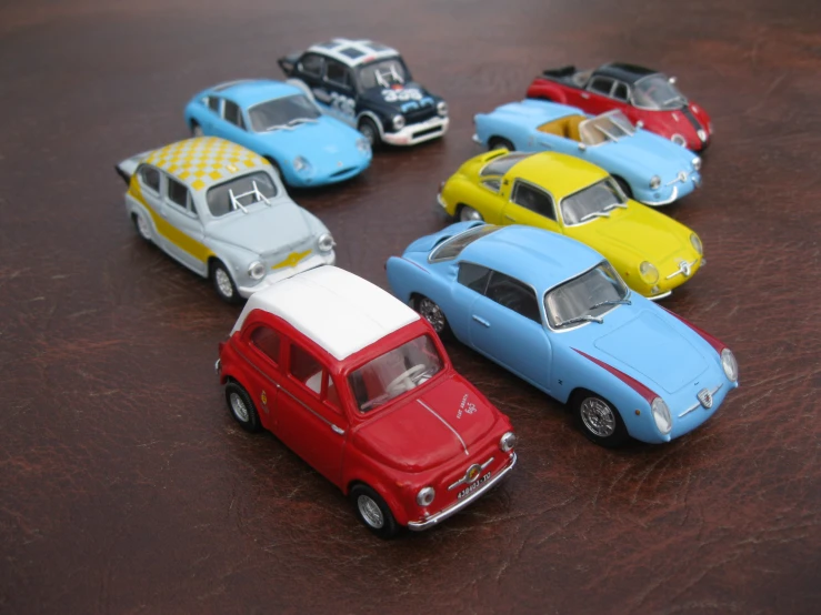 small toy cars on top of a brown surface