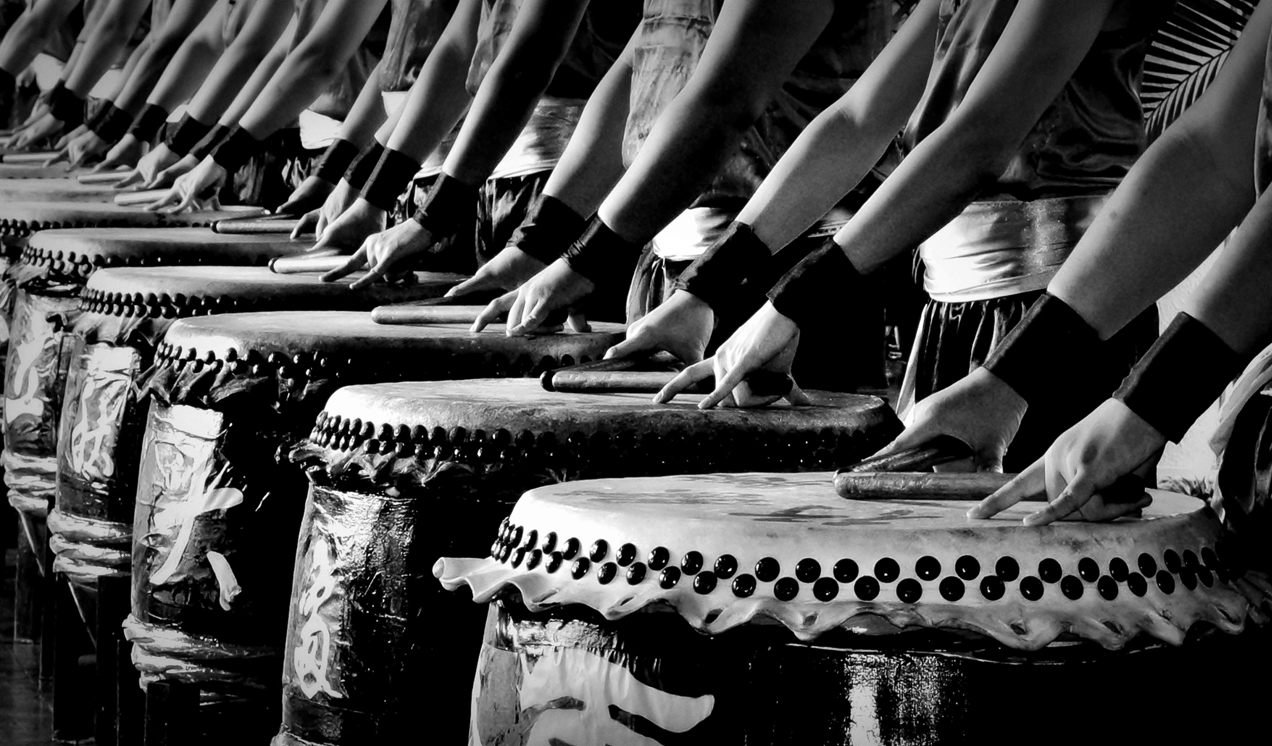 legs in sandals sitting on stools in black and white po