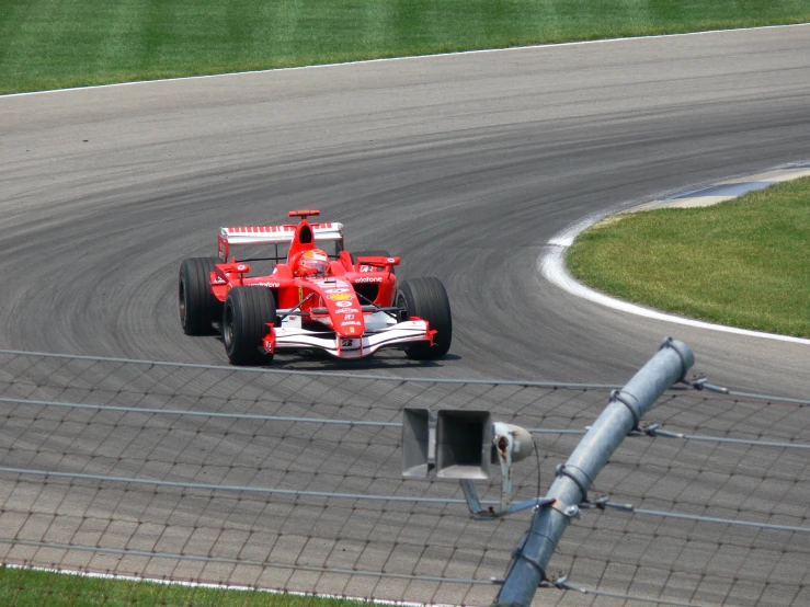 a red race car driving on a race track