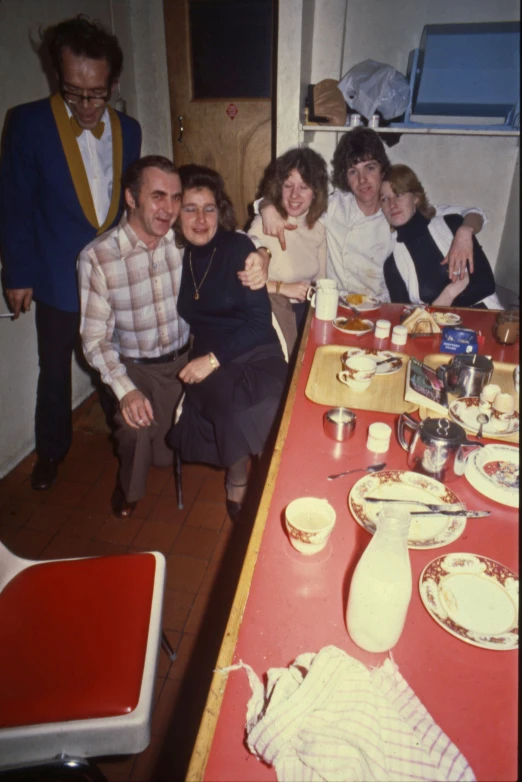 a group of people sit around a table