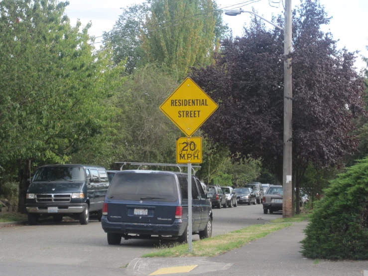 several cars are travelling down this roadway in both directions