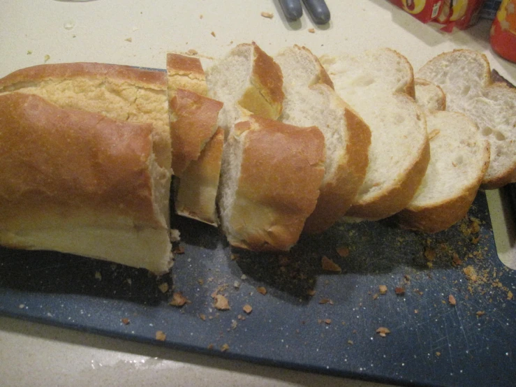 a sliced loaf of bread on top of a blue  board