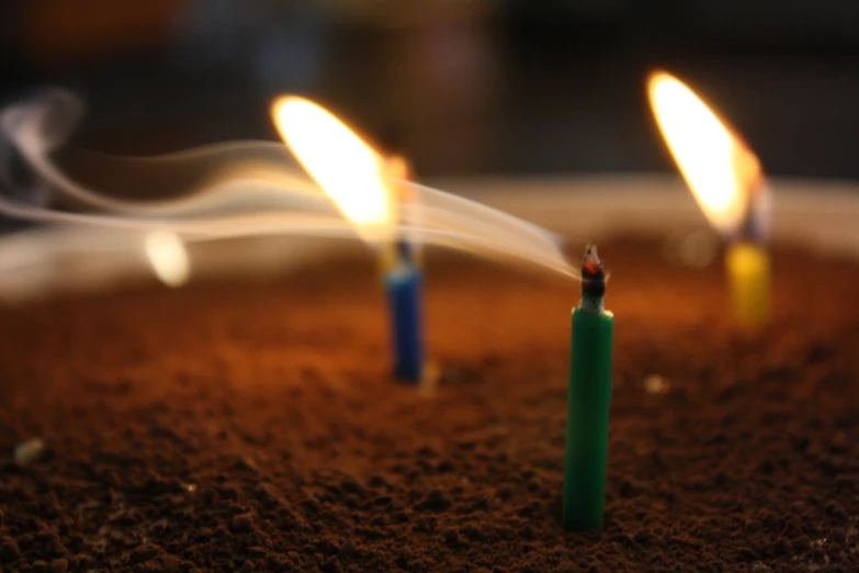 a closeup view of some small candles with smoke