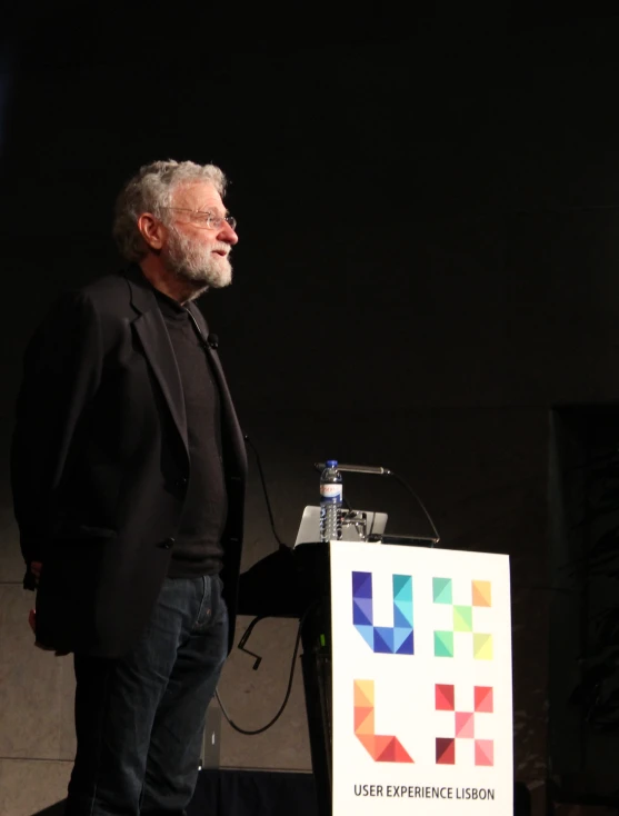 a man standing at a podium speaking into a microphone