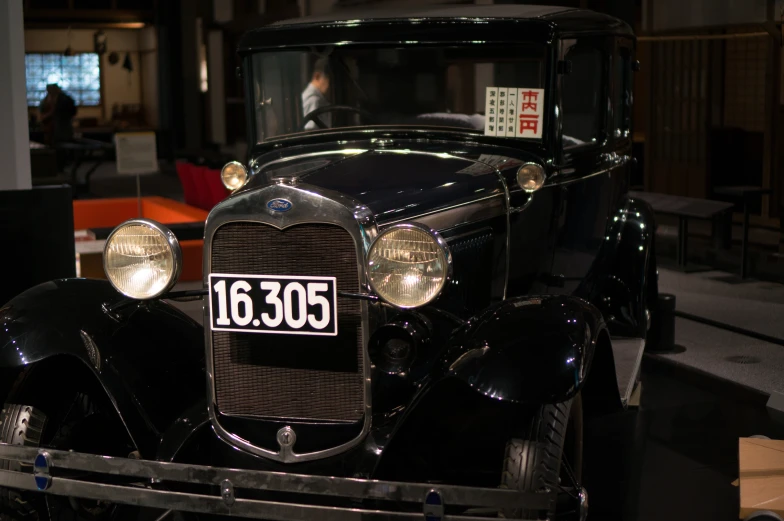 an old car on display at an antique show