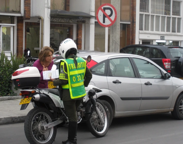 a police officer is standing near a car