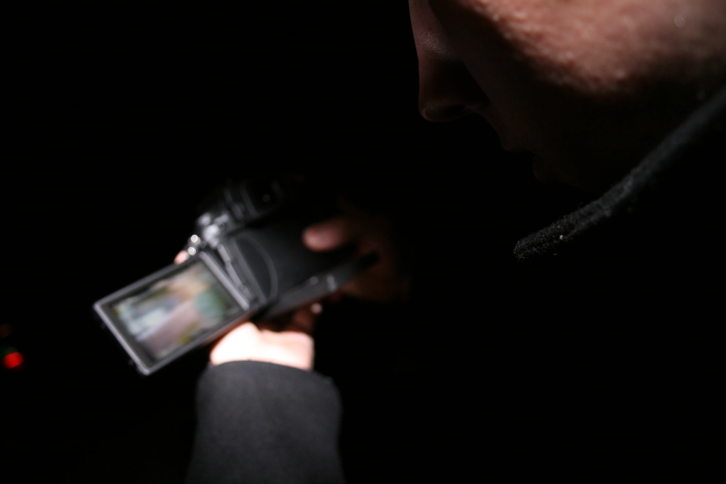 a person standing next to a black object