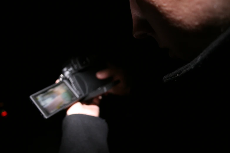 a person standing next to a black object