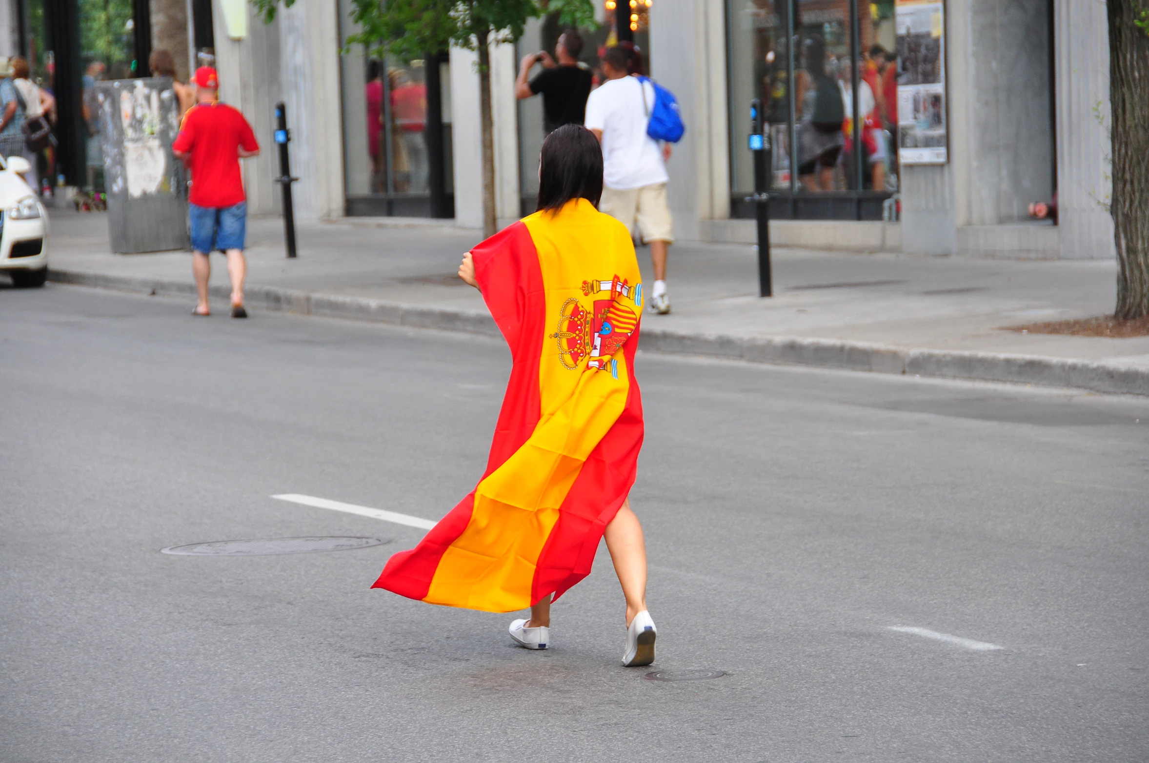 a woman dressed in a flag costume crossing a street