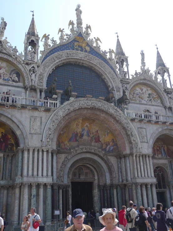 two people standing in front of an ornate church