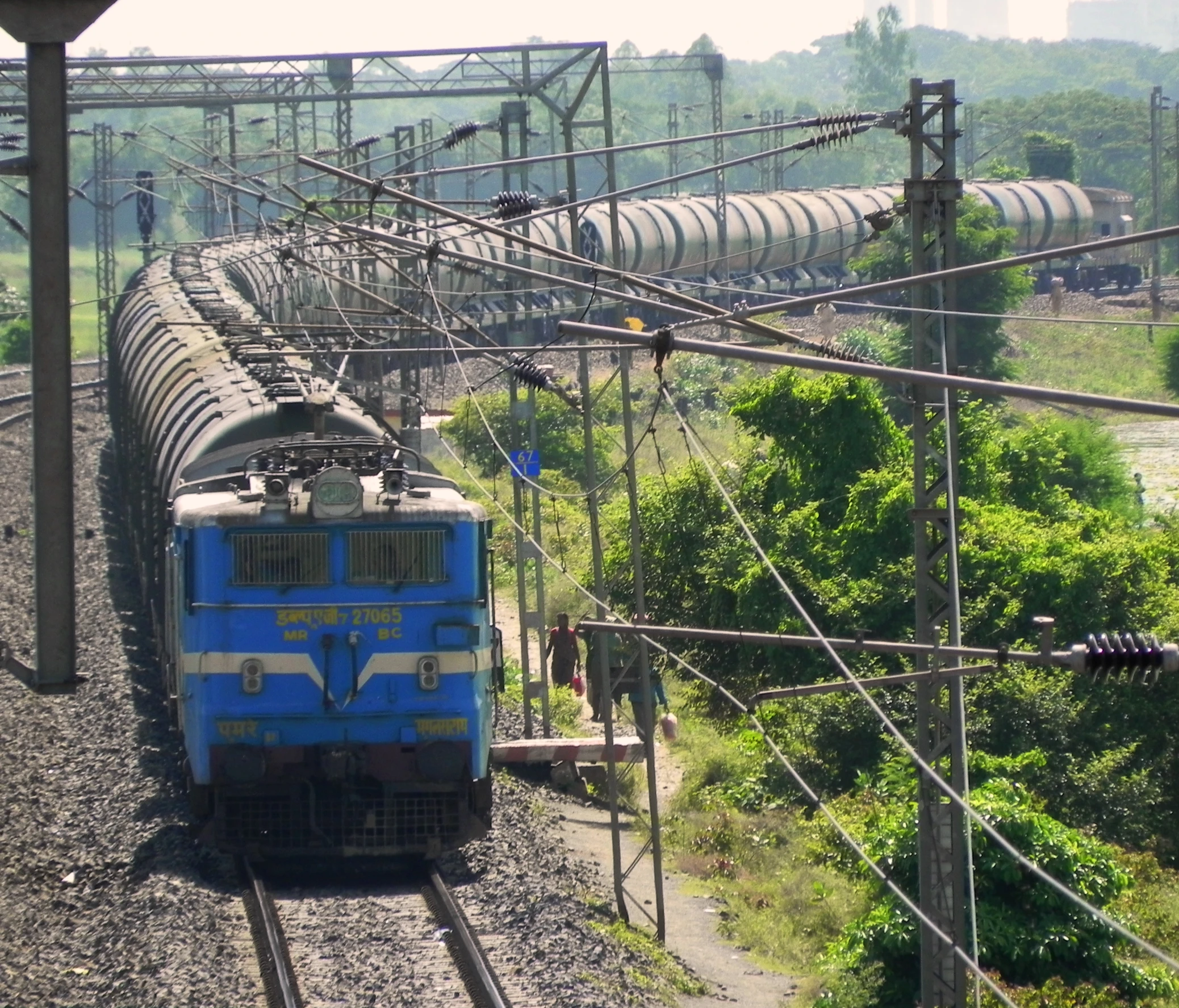 a train moving down the railroad tracks with power lines overhead