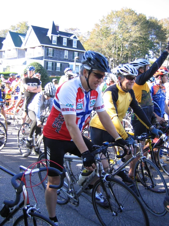 the group of cyclists is riding on a city street