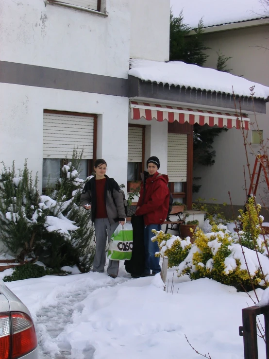 two women standing in front of the outside of a store